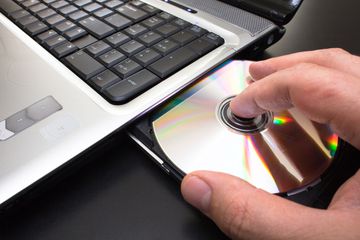 A Blu-ray inserted into a laptop to rip and encode.