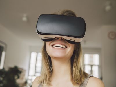 Laughing woman wearing virtual reality headset