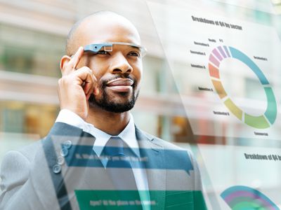 Man wearing smart glasses and looking at augmented reality charts