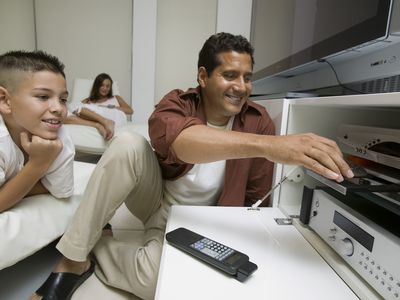 Father and son using a DVD player.