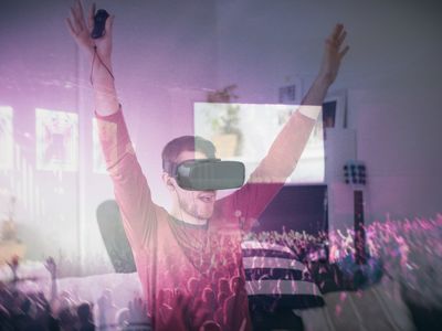 Person wearing VR headset with concert footage superimposed