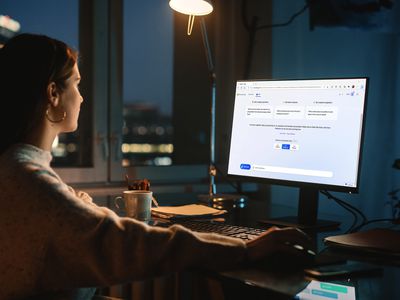 A woman using the Bing AI chatbot in a dark room.